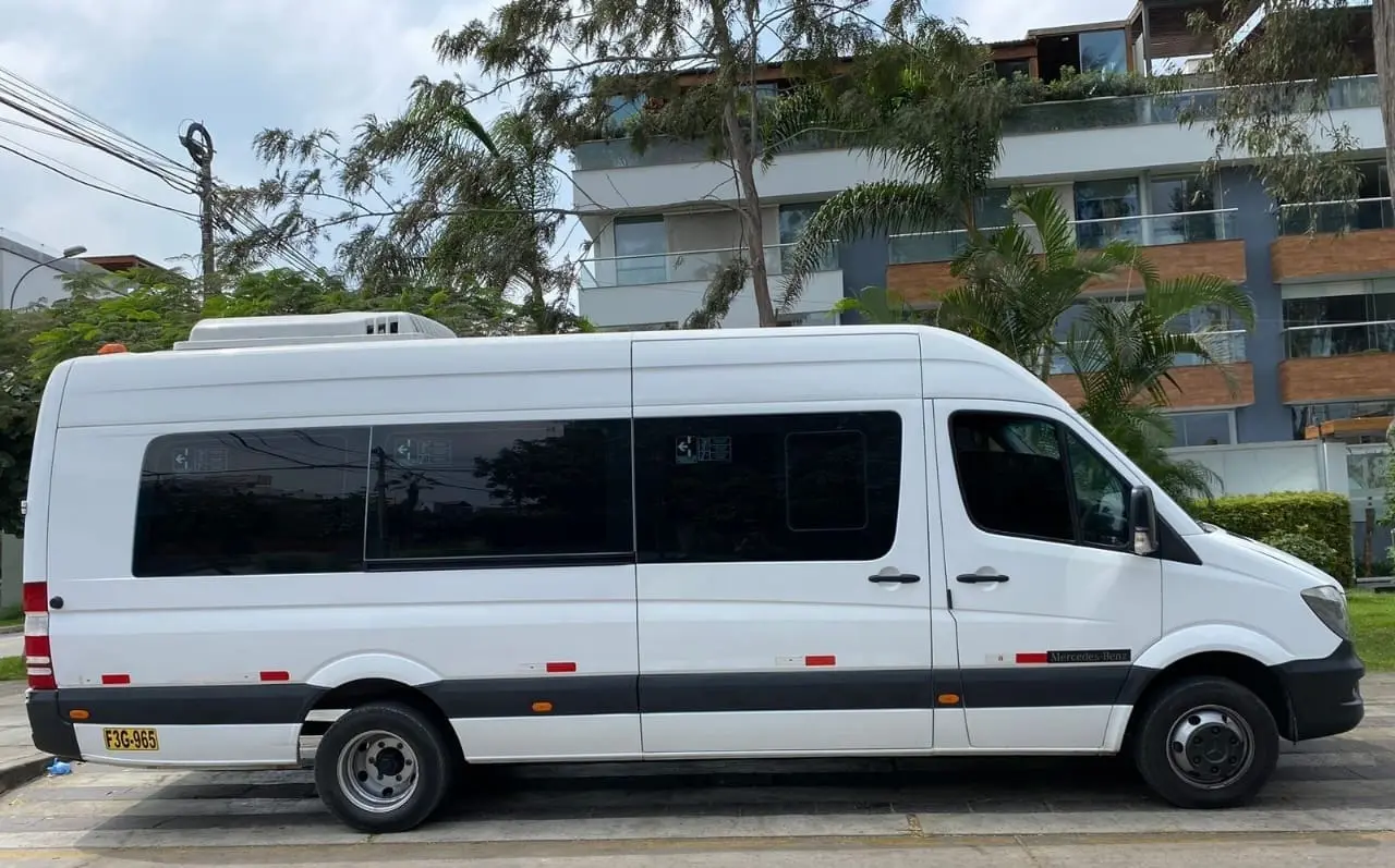 Sprinter blanca de Taxi Van Lima estacionada en Lima, vehículo de alta capacidad para grupos grandes que viajan desde el Aeropuerto Jorge Chávez hacia Miraflores o San Isidro.